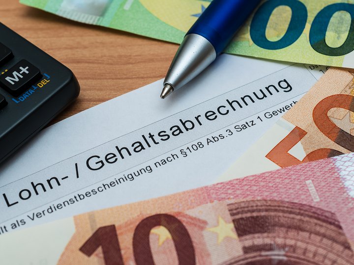 Steuerberatung, Buchhaltung und Lohnabrechnung Lohnabrechnung mit Eurogeld, Kugelschreiber und Taschenrechner