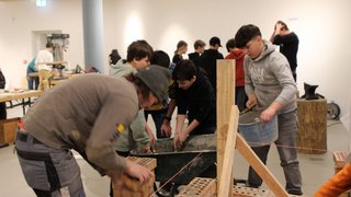 Junghandwerker Kinder lernen Mauerbau in einem Workshop mit Ziegeln und Mörtel