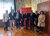 Home Gruppenfoto von acht Personen vor Fahnen und rotem Stadt Bozen Schild