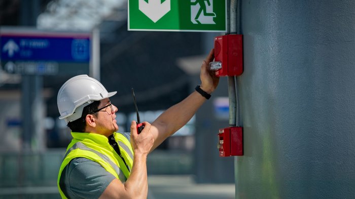 Mittelschule Klausen: Traumberufe in Gastgewerbe, Handwerk, Handel und Dienstleistungen vorgestellt Mitarbeiter in Warnweste öffnet mit einem Schlüssel eine Notausgangstür
